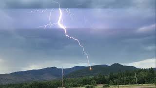 Lightning strikes tree and starts fire.