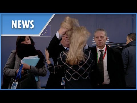 Bizarre moment Juncker ruffles woman's hair