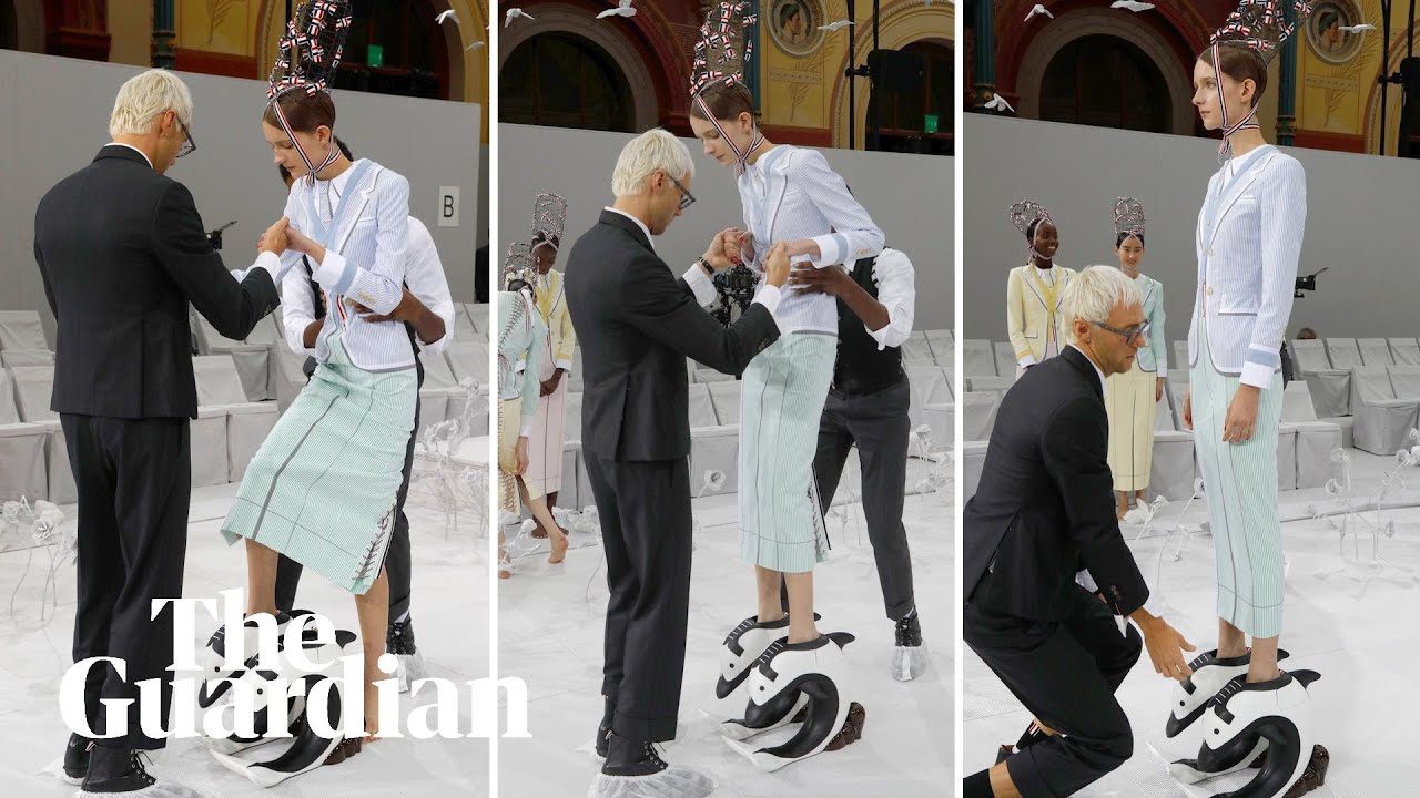 Models helped into extreme shoes during Paris fashion week