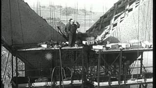 Workers and engineers on framework of a tall tower which is one of the supports f...HD Stock Footage