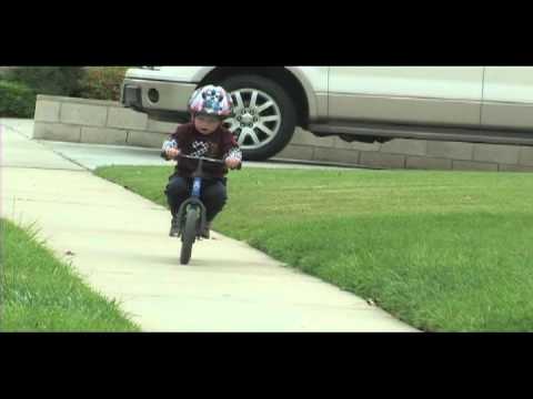 2 year old riding Strider balance bike- Brayden