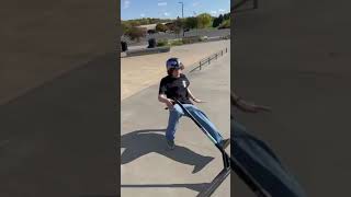Scooter rider grinds handrail at skatepark then falls and lands on the back of his head at skatepark