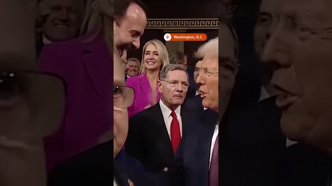 'This is not normal' sign yanked away as Trump arrives in Congress | REUTERS