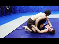 Male and Female Athletes Practicing Ground Submissions