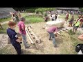 Volunteers help move three and a half tonne ton standing stone to mark Butser Ancient Farm