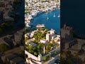 Vertical video. Bodrum, Turkey. Evening aerial drone view of Bodrum Castle illuminated by sunset,...