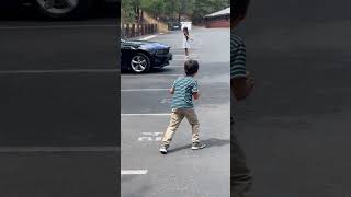 Boy crashes RC car/truck into older sister running away in Heelys in parking lot