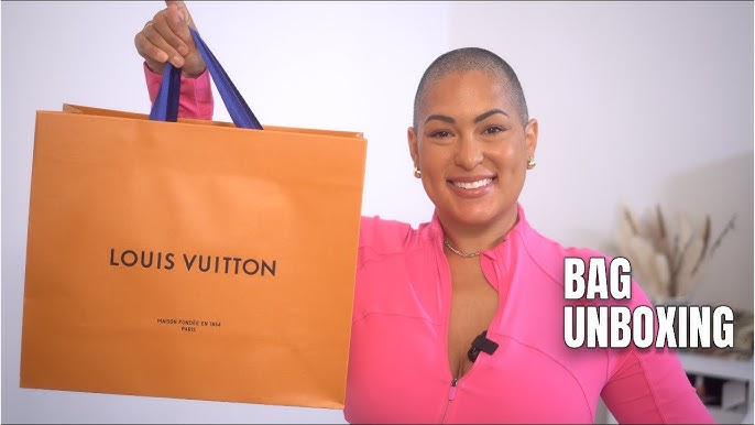 Woman Shopping LV - A person holding a louis vuitton bag in an