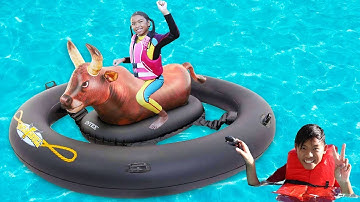 Wendy Plays in the Pool on Inflatable Bull Toy
