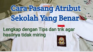cara  memasang atribut sekolah (nama sekolah, logo sekolah) dan logo osis pada saku baju