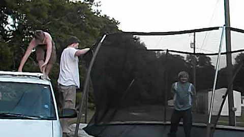 Crazy kids jumping off the vehicle onto the trampo...