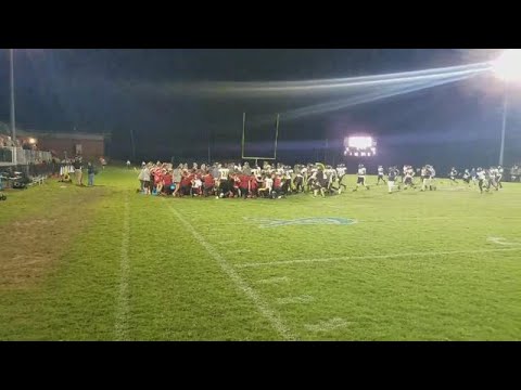 Peach County football players pray with Pike Co.