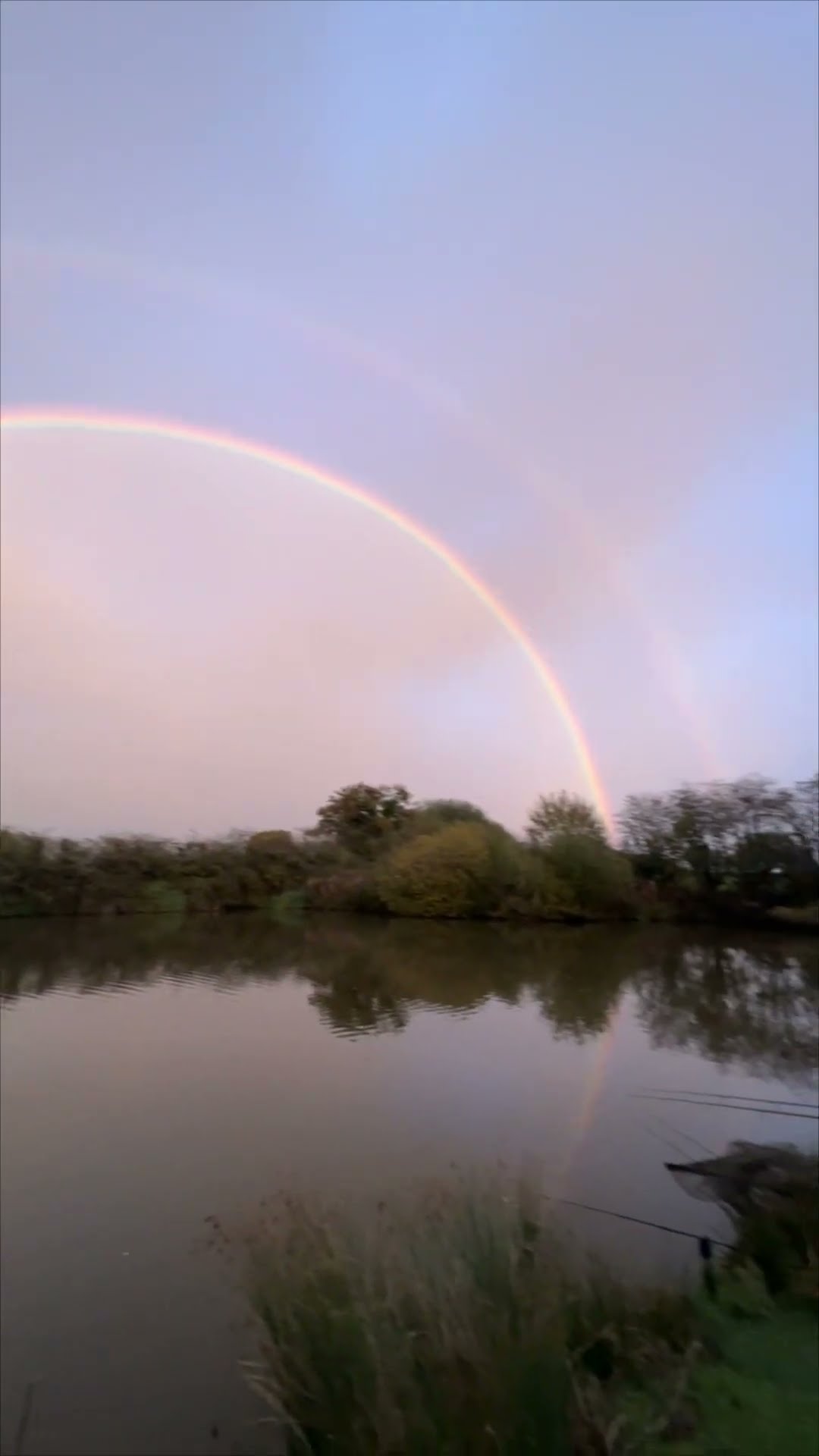 Stunning Double Rainbow Forms a Perfect Circle Over a Serene Lake