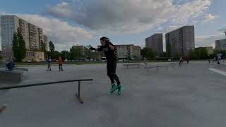 Inline skater attempts to grind rail and crashes into platform of ramp at skatepark
