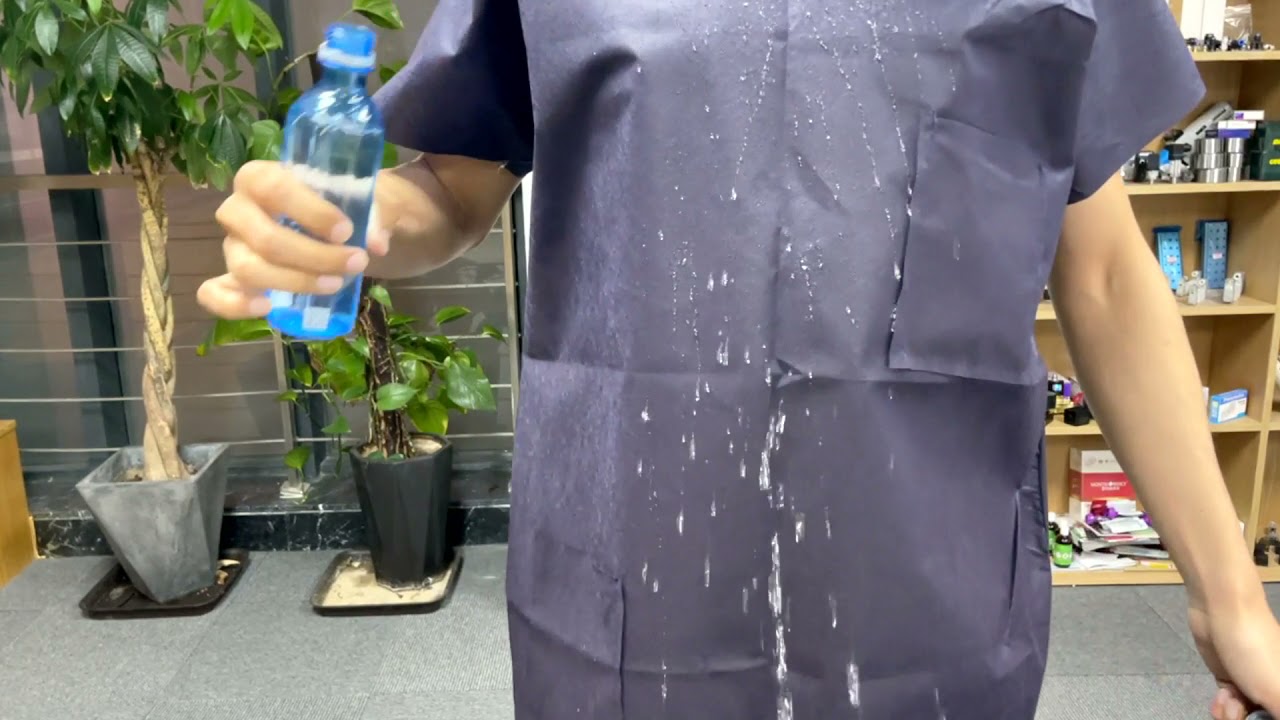 Disposable Dark Blue Spunbonded Polypropylene Shirts with Short Sleeves and Pockets. Fluid Resistant