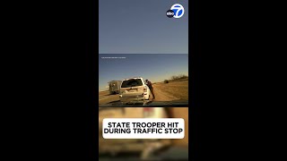State trooper sent flying after SUV hits car during traffic stop