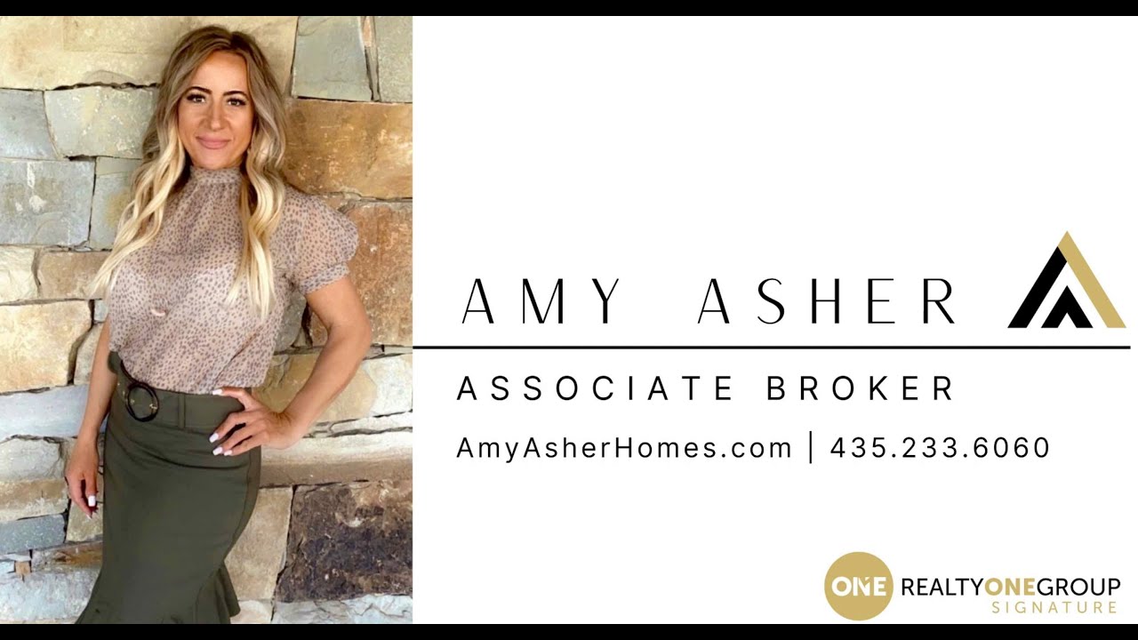 Professional real estate agent Amy Asher posing in front of a stone wall, promoting her services as an associate broker, with contact information and branding for Realty ONE Group.