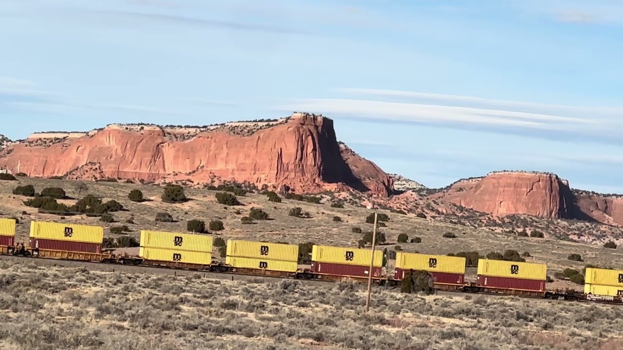 Beautiful scenic New Mexico landscape with railroad train in the distance 