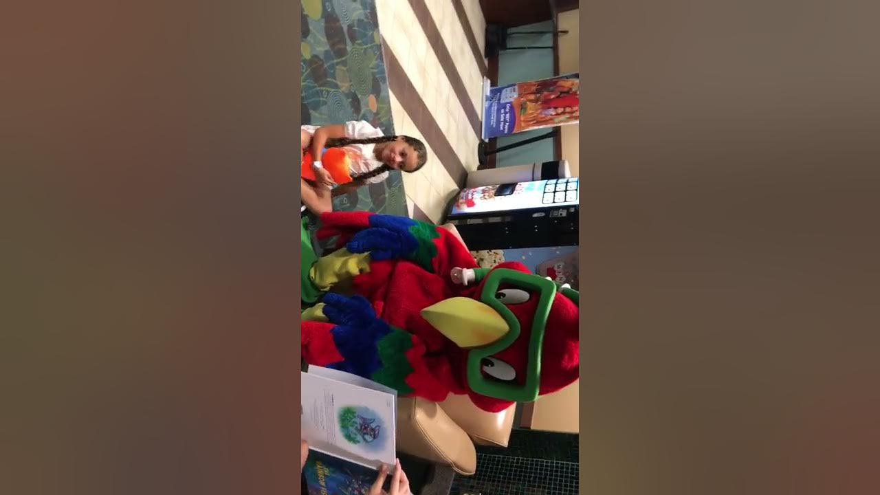 Samy reading to the Mascot Coco at Coco key YouTube
