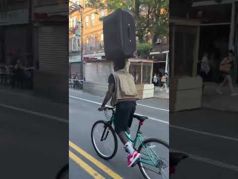 Brooklyn Cyclist Balances Suitcase on His Head