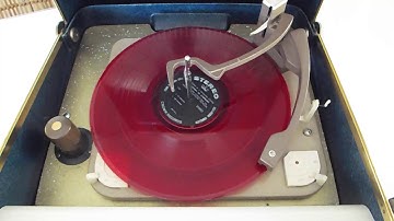Motorola CALYPSO 4 speed automatic portable record player playing an LP record.