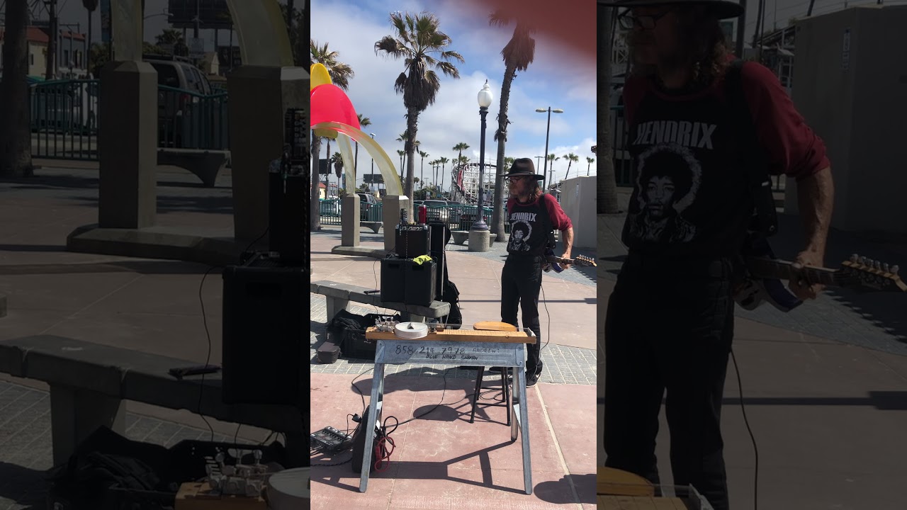 Guitar behind my back playing scorching blues on the street.