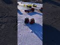 At the ice mining site ice trucks are loading and unloading with each piece falling off#Ha