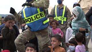 Augmentees and Security Forces personnel interact with Afghan evacuees B-Roll