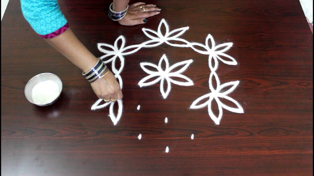 flower kolam with 7 to 4 interlaced dots- flower muggulu designs ...