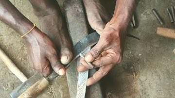 Blacksmith making billhooks