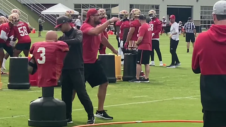 49ers DL coach Kris Kocurek runs a takeaway drill ...