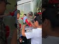A heartbroken grandmother bids farewell to her grandson as he leaves for military service