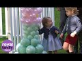 Prince George and Princess Charlotte play with balloons and pet animals