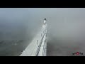 Starting to freeze 30 wind chill causing thick fog around michigan city lighthouse 4k drone footage