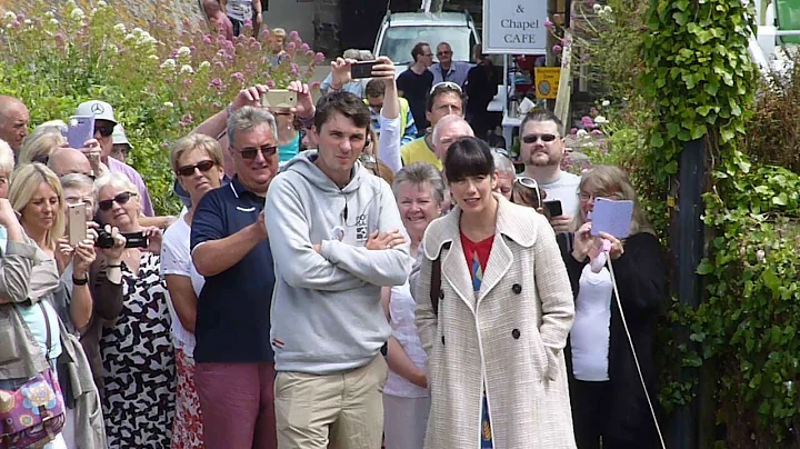 A little girl interupts Caroline Catz filming a sc...
