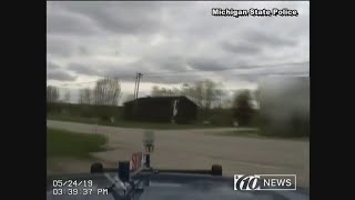 Michigan police officer pulls girl out of dump truck's path