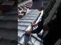 the process of installing curved roof tiles on cement mortar on the roof ridge of a building #shorts