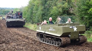 Wheeled and Tracked Military Vehicles driving up a Muddy Track