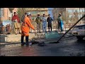 Men clean up street after deadly Kabul rocket attack | AFP