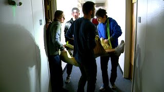 students carrying injured person