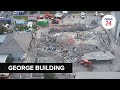 Watch  birds eye view drone footage of the building collapse in george