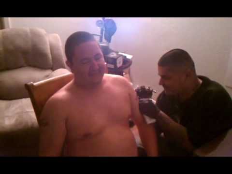 Nick getting his sons names tatooed on his arms