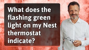 What does the flashing green light on my Nest thermostat indicate?
