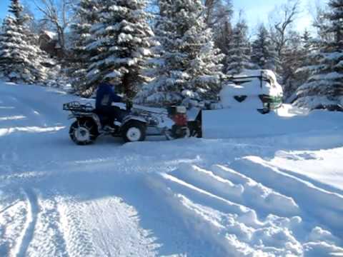 How do you attach a snow blower to a 4 wheeler?