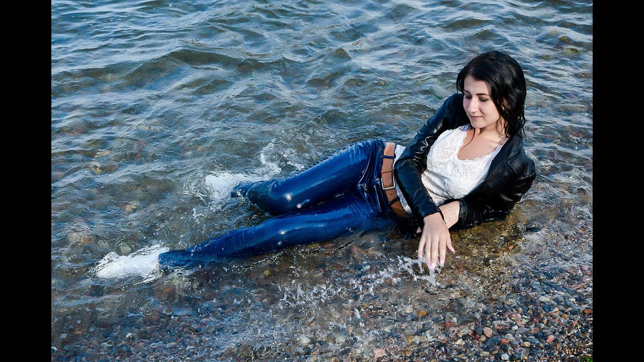 cute girl posing in wet clothes on the beach by the sea for wetlook video