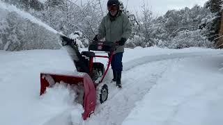 Troy-Bilt Storm 2420 snowblower in deep heavy snow, on gravel and up hill.