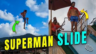 Guy Does Superman Pose Jumping off Slide