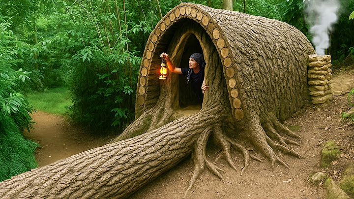 I built a bushcraft survival house hidden deep beneath a giant fallen tree root