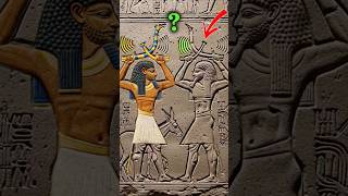 What are these ancient figures really holding above their heads? #shorts #ancientegypt #mystery