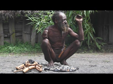 Dani tribe man selling kotekas